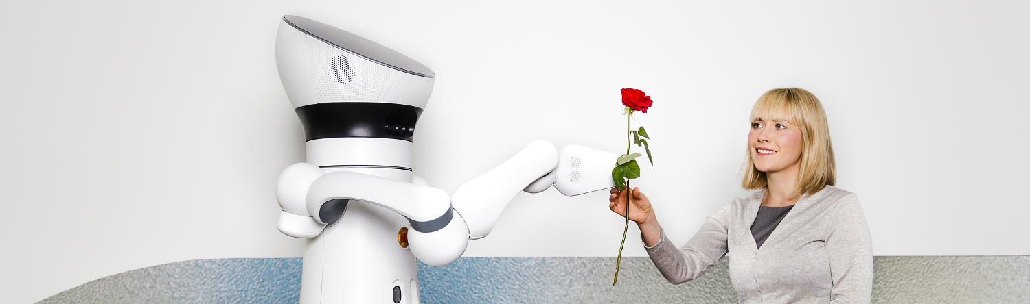 Assistant robot gives woman a rose 